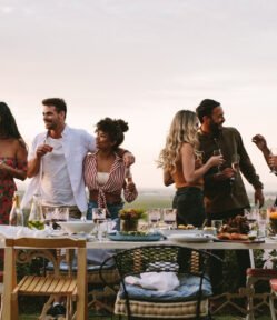 Group of friends enjoying drinks at sunset overlooking Queensland’s Granite Belt, reflecting the relaxed social atmosphere of Conrad Distillery as a premium Australian spirits producer