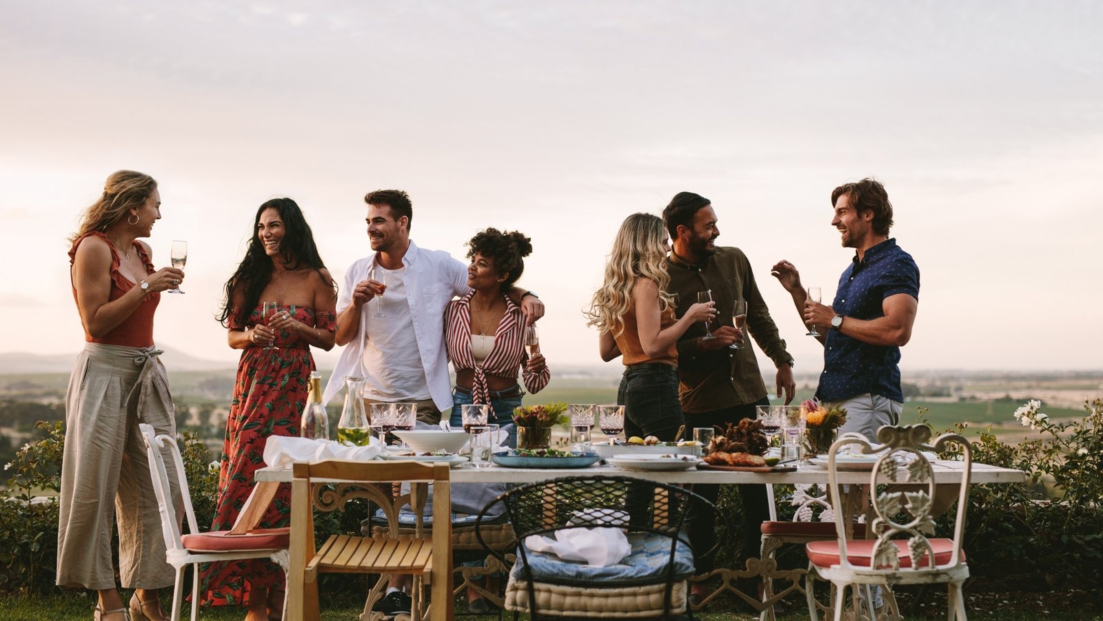 Group of friends enjoying drinks at sunset overlooking Queensland’s Granite Belt, reflecting the relaxed social atmosphere of Conrad Distillery as a premium Australian spirits producer