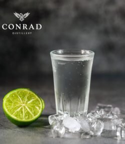Ice-cold Conrad Premium Australian Vodka served in a frosted shot glass with fresh lime and ice.