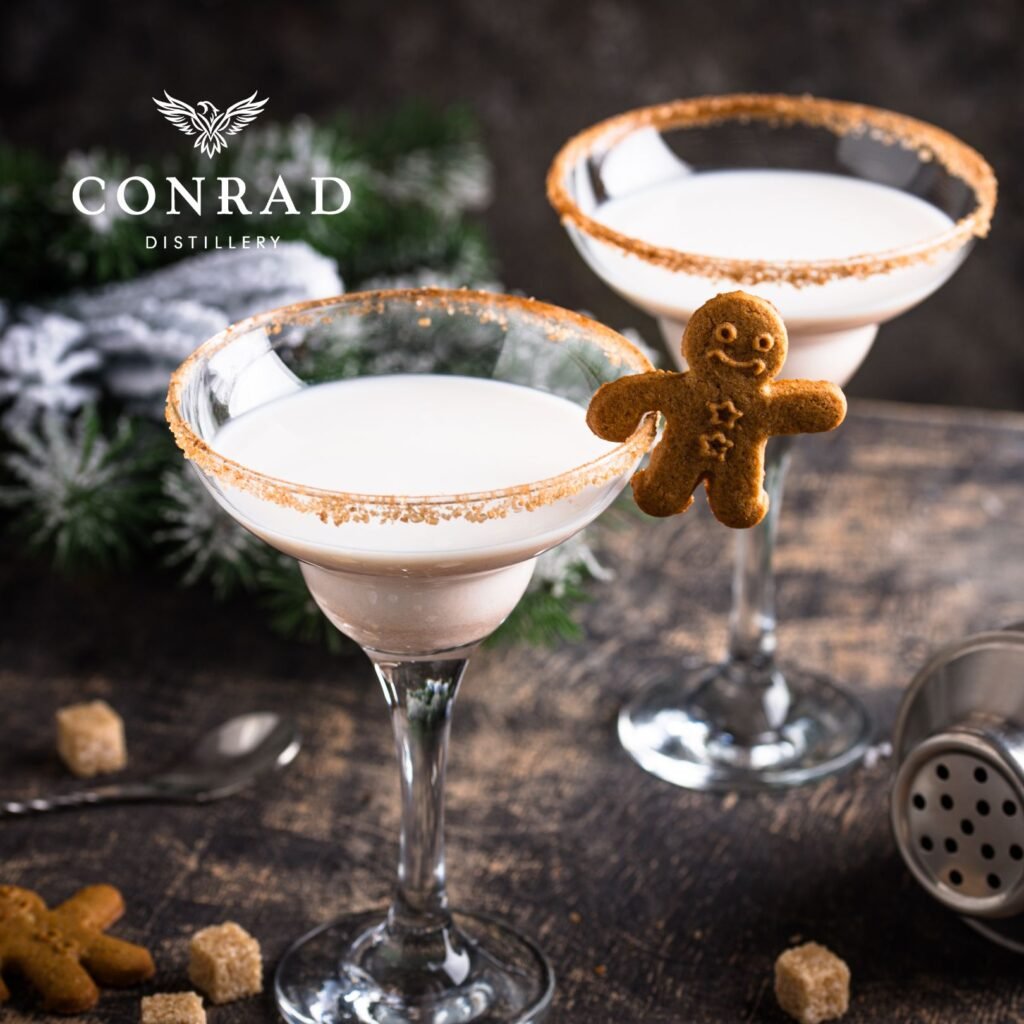 Two Gingerbread cream cocktails in sugar-rimmed glasses garnished with mini gingerbread men
