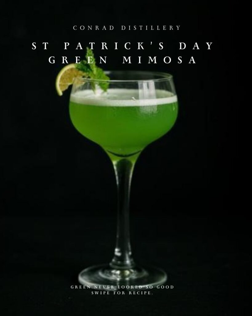 Bright green mimosa cocktail garnished with lime and mint in a coupe glass for St Patrick’s Day celebration.
